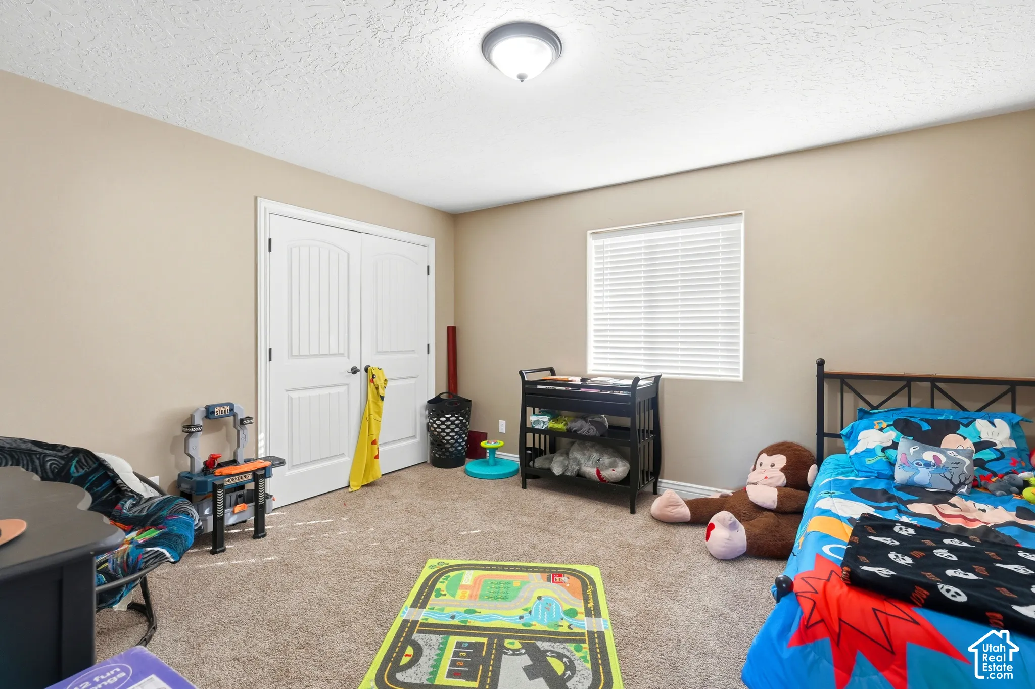 Neutral-toned walls complement the textured carpeting