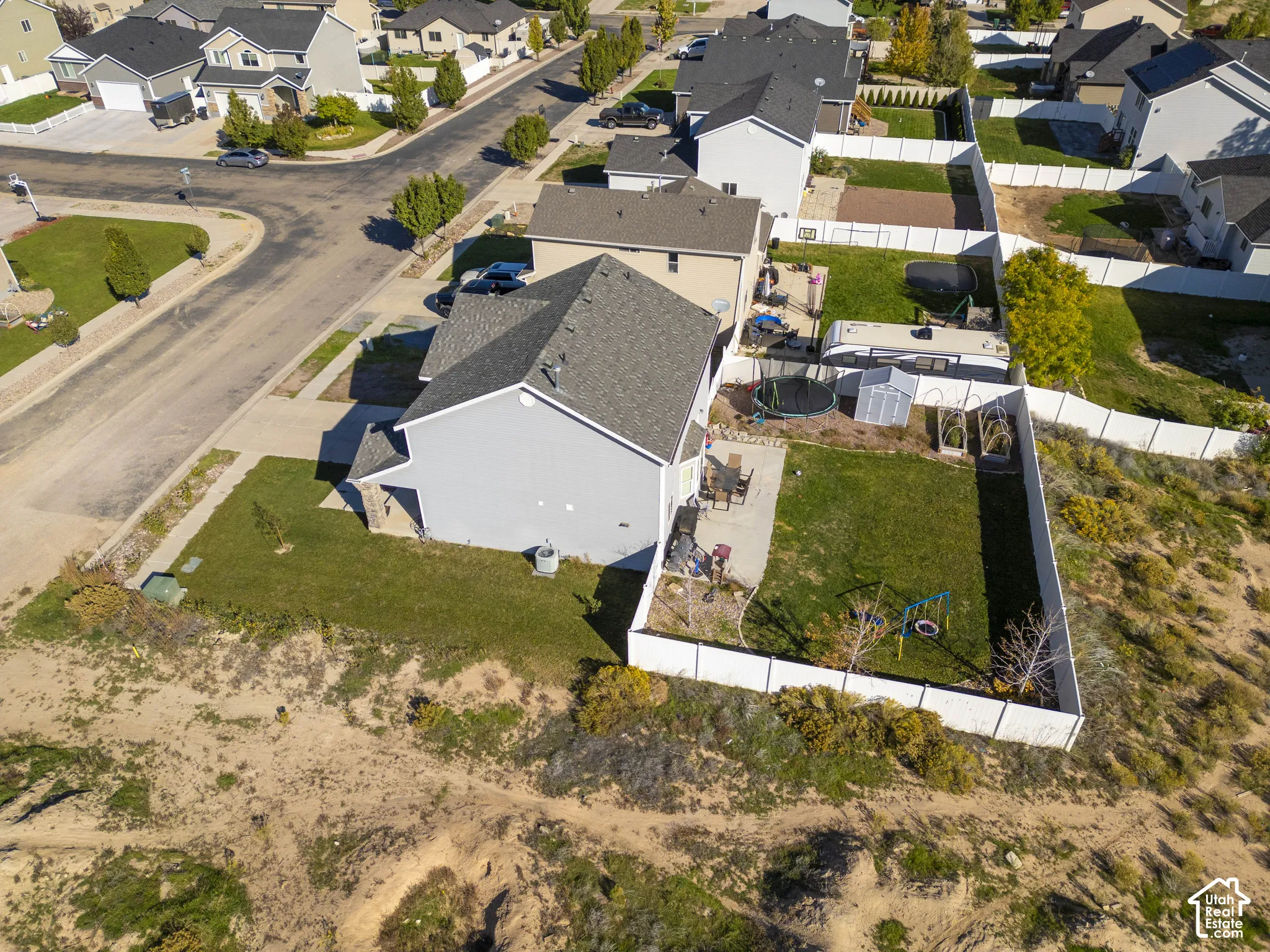 Private backyard featuring a concrete patio, fenced perimeter, and established lawn area