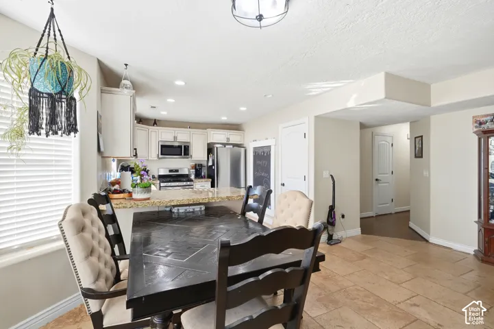 Kitchen with light cabinetry, stainless steel appliances, and a light-toned countertop