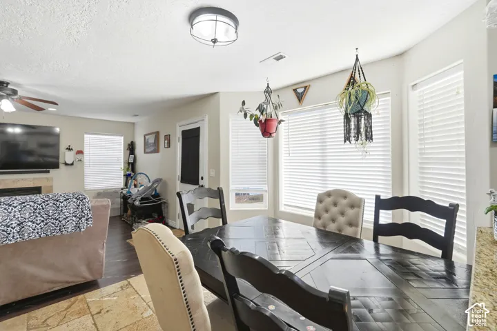 Dining area with recessed lighting, multiple windows with blinds, and durable tile flooring