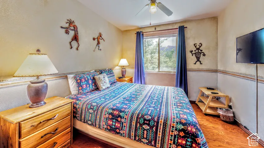 Wood-finish flooring with a ceiling fan light fixture