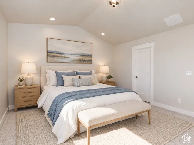 Vaulted ceiling, recessed lighting, carpet flooring, two paneled doors, and ceiling-mounted light fixture.  Virtually Staged.
