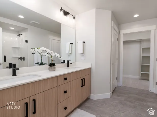 Dual vanity with stone countertops and wood-finish cabinetry