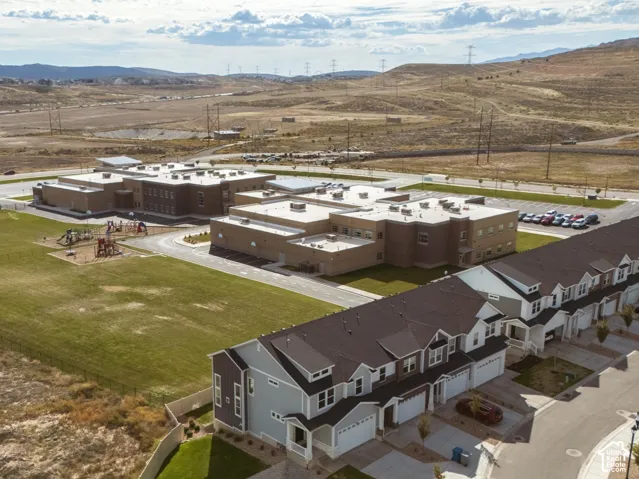 Row of townhomes featuring attached garages and covered entryways