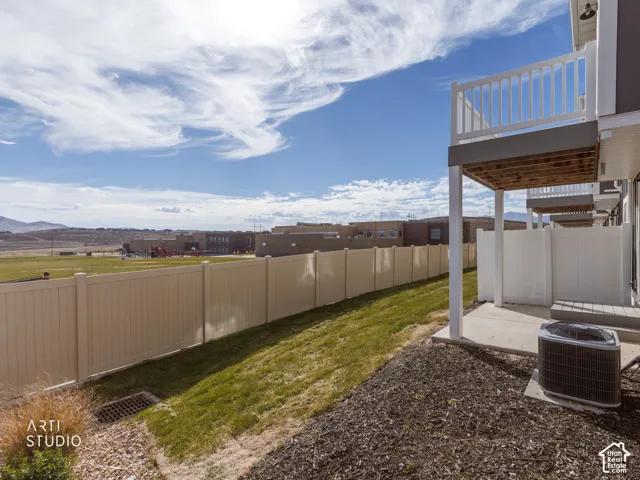 Rear patio with concrete slab and privacy fencing