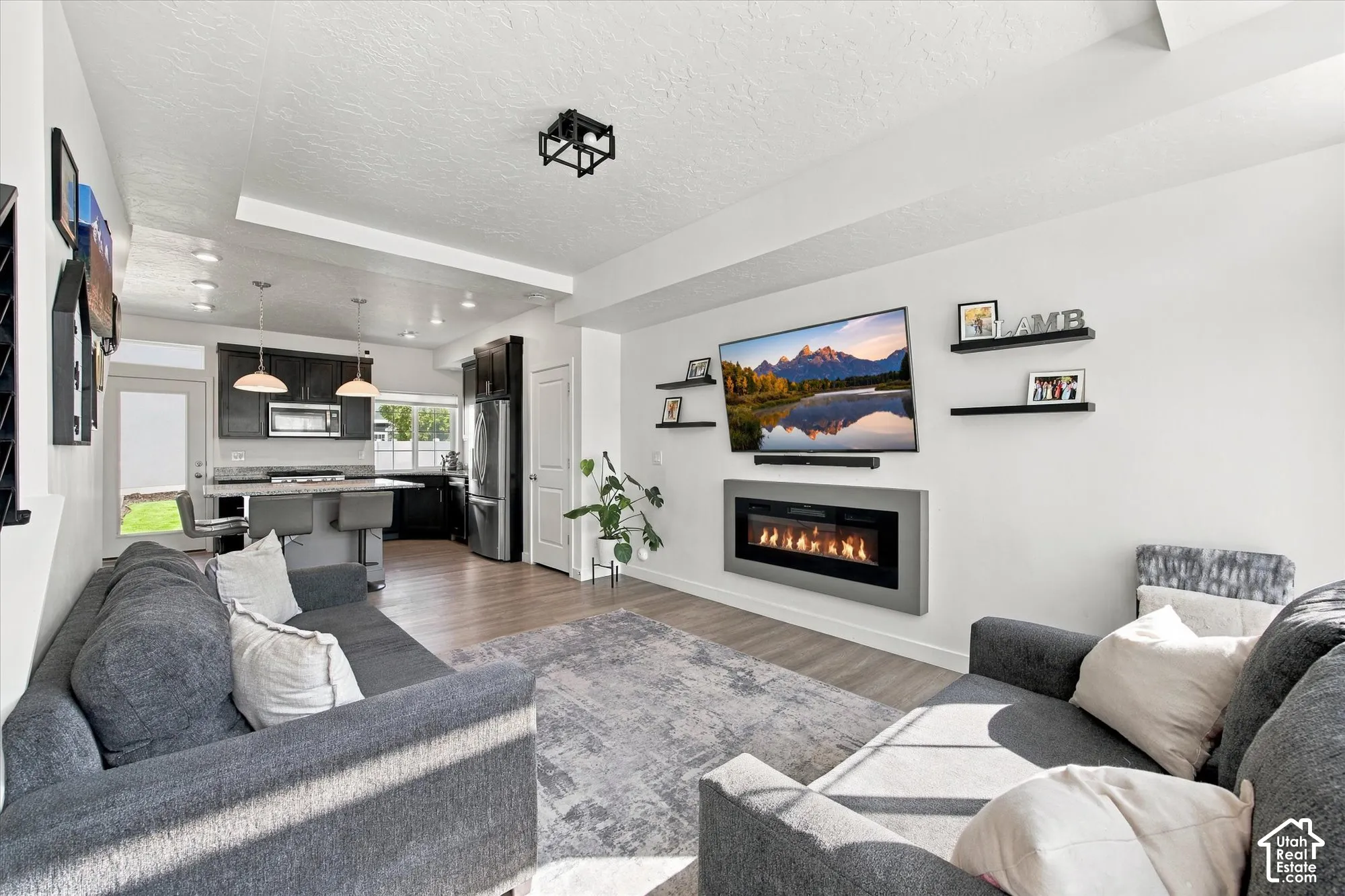 Living area featuring an electric fireplace and wood-finish flooring