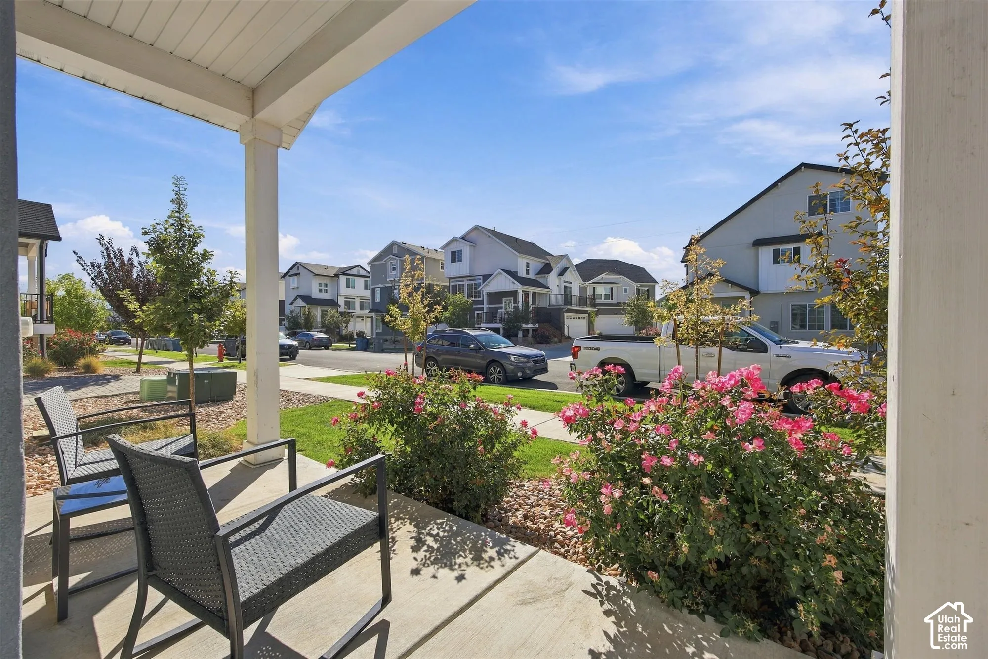 Front porch with concrete flooring and white support pillars