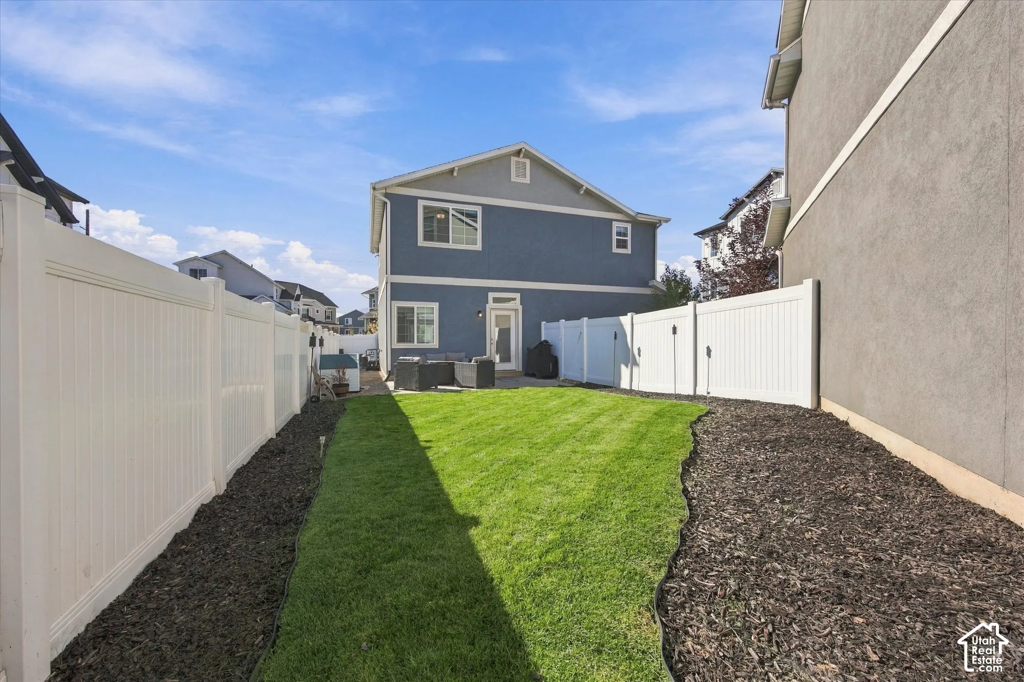 Lush green lawn with defined landscape beds