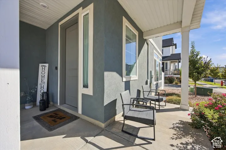 Covered porch with a finished concrete surface and recessed lighting