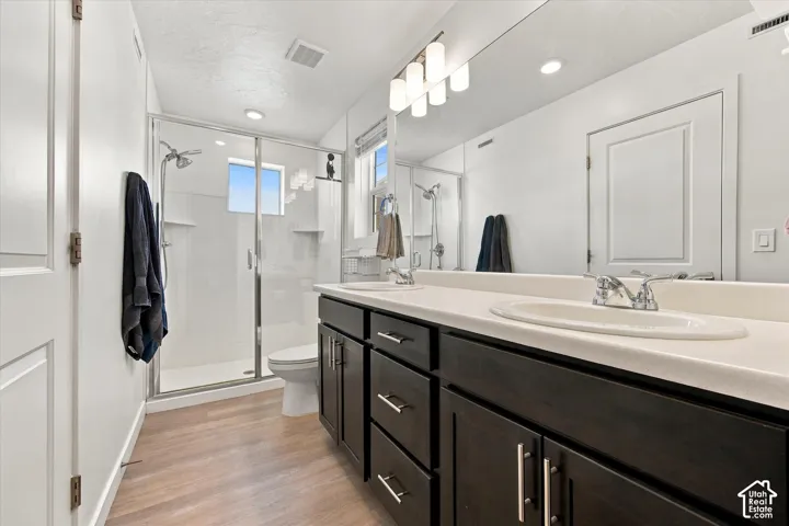 Dual sink vanity with dark wood-finish cabinetry