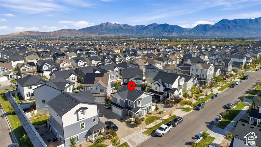 Aerial perspective showcasing a residential neighborhood with distant mountains
