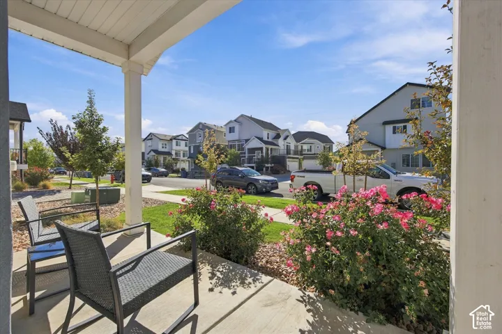 Front porch with concrete flooring and white support pillars
