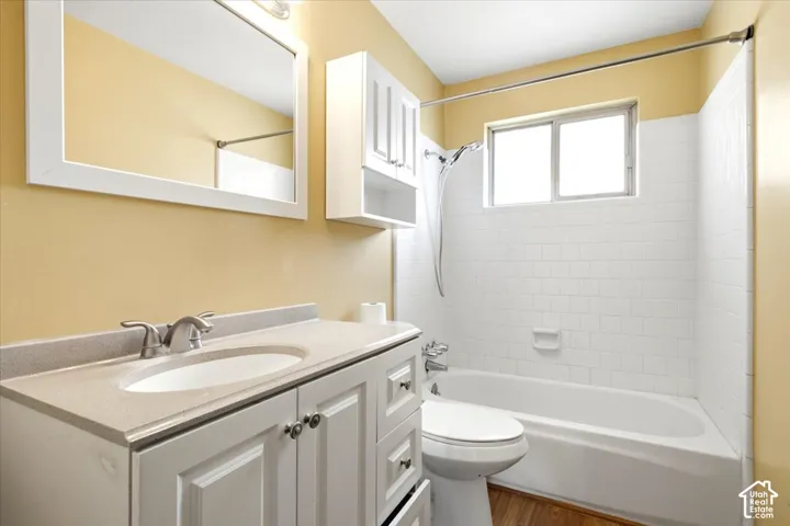 White vanity with dual-door cabinetry and integrated sink