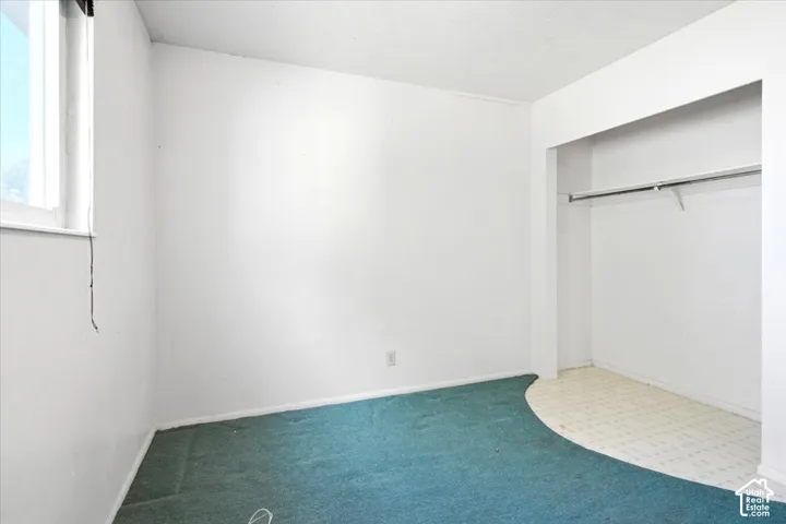 Recessed closet with a metal hanging rod and shelf