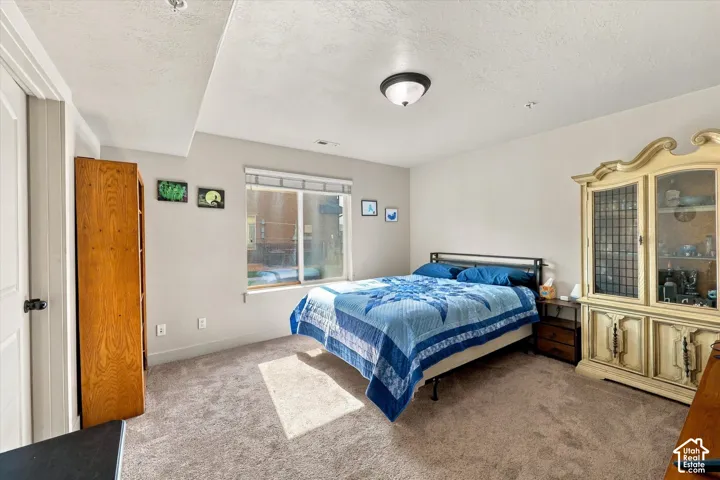 Recessed lighting, neutral wall tones, window with natural light, and plush carpeting