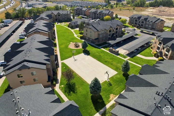 Community grounds featuring a basketball court, walking paths, and landscaped green spaces