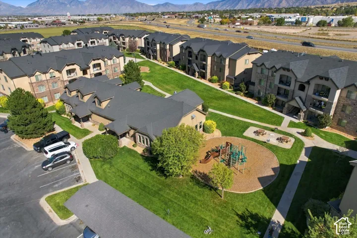 Expansive green spaces with mature trees, dedicated parking areas, and a playground