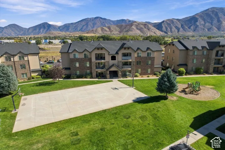 Multi-story residences featuring stone and stucco exteriors, surrounded by manicured lawns