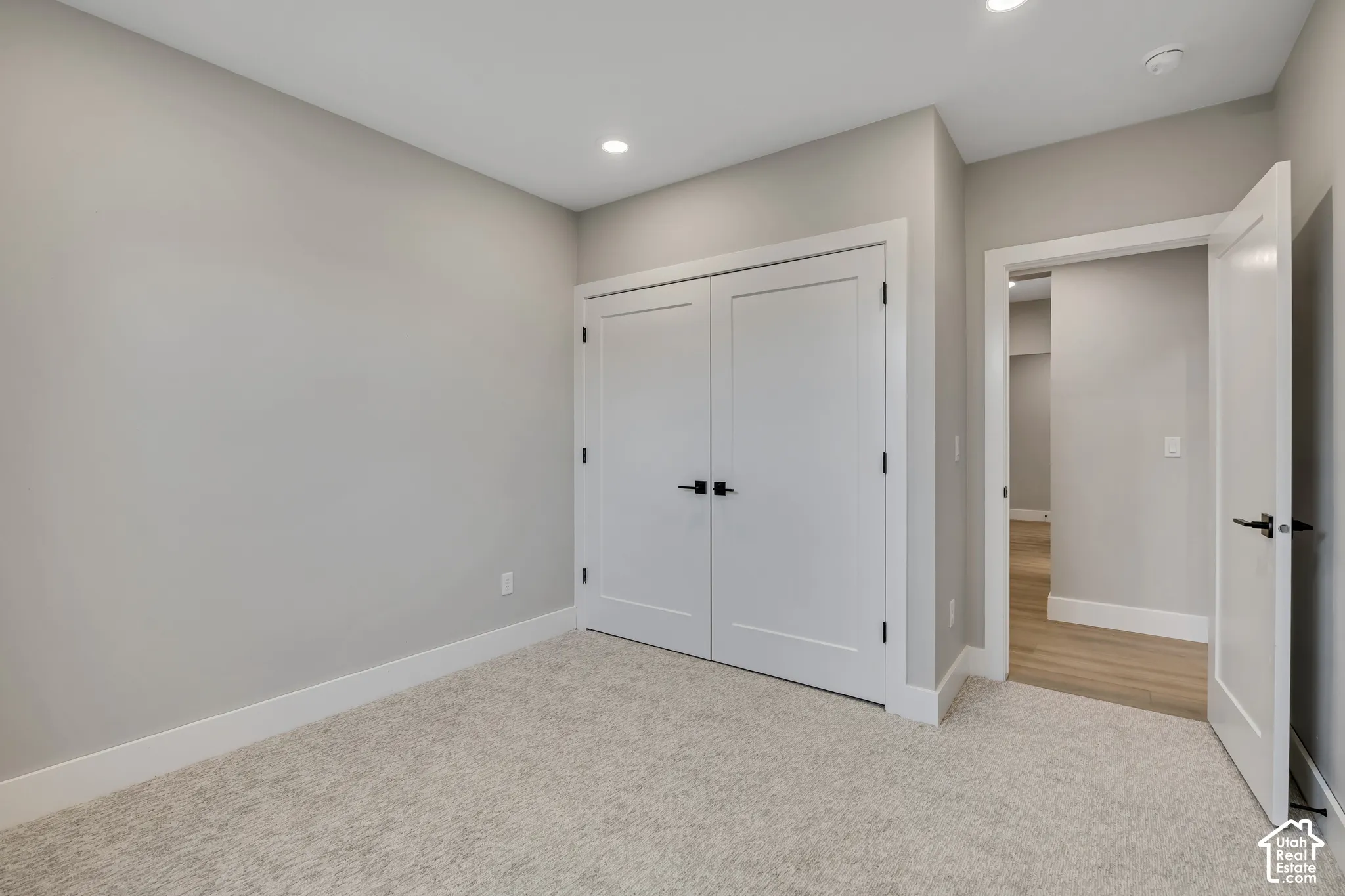 Neutral-toned walls complement plush carpeting