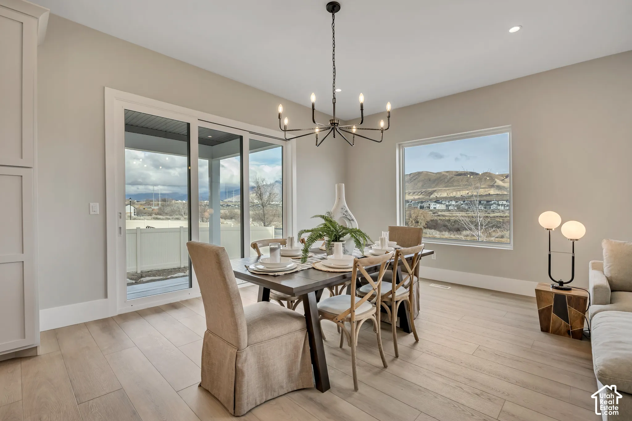 Light-toned wood-finish flooring, sliding glass door, fixed rectangular window, and a built-in storage cabinet