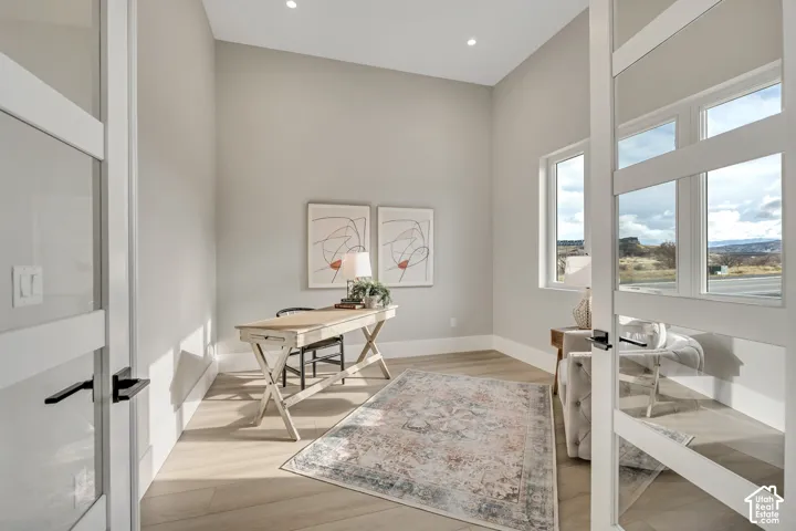 Room featuring recessed lighting, light wood-finish flooring, and multiple windows
