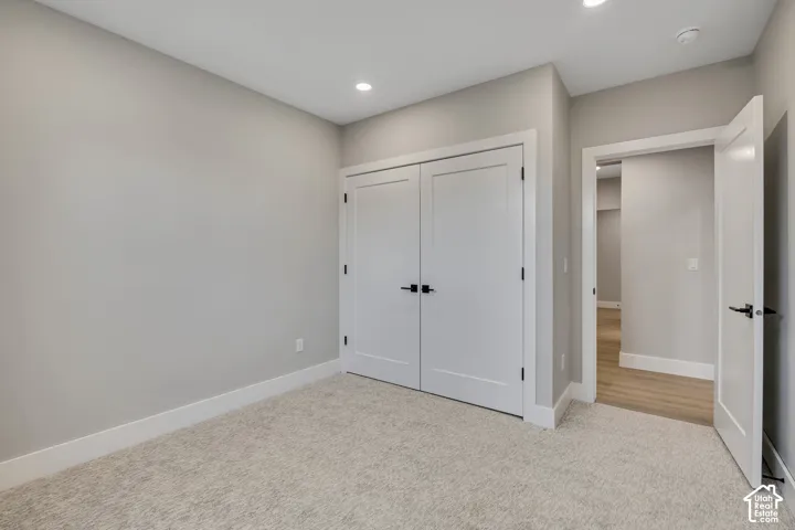 Neutral-toned walls complement plush carpeting