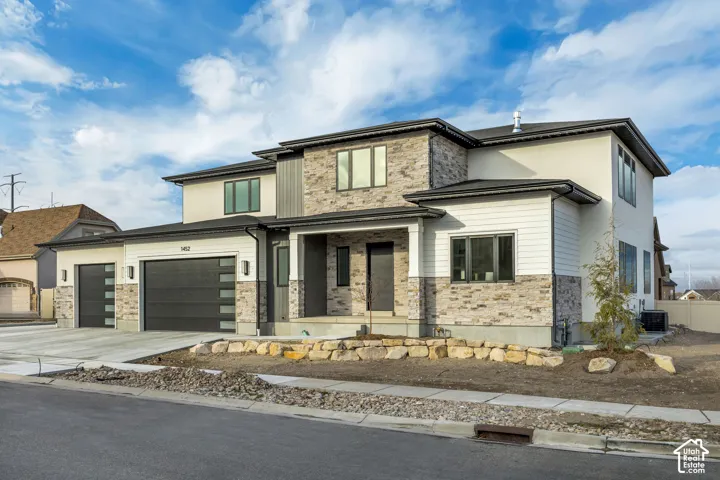 Modern two-story exterior with stone and siding accents