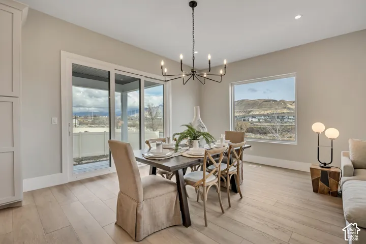 Light-toned wood-finish flooring, sliding glass door, fixed rectangular window, and a built-in storage cabinet