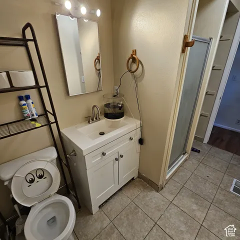 White vanity cabinet with integrated sink, rectangular mirror, and overhead vanity lighting