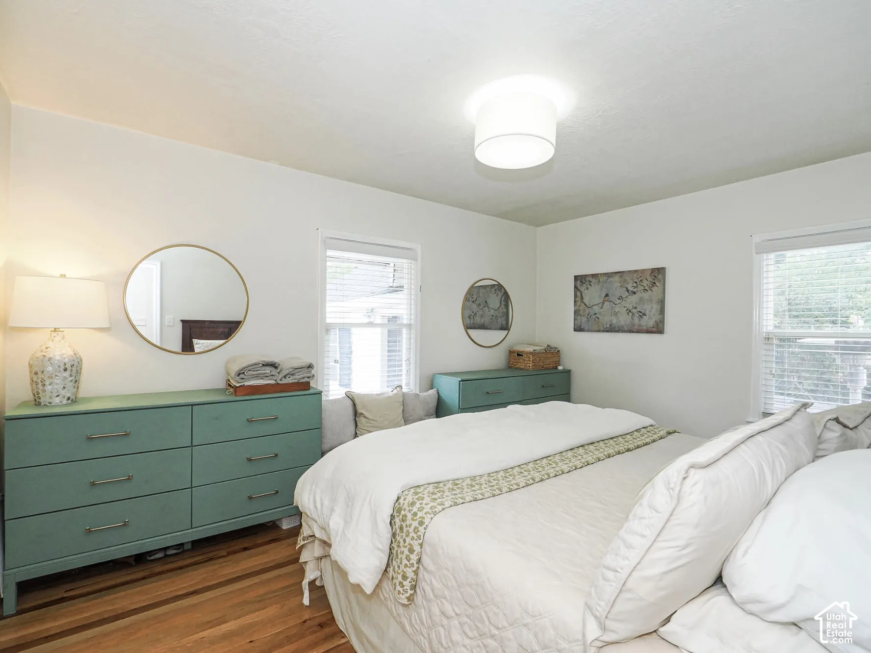 Hardwood flooring, white walls, and a ceiling-mounted light fixture
