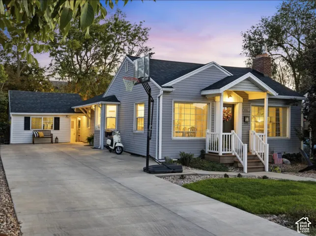 Siding exterior with a covered porch entry featuring white railings