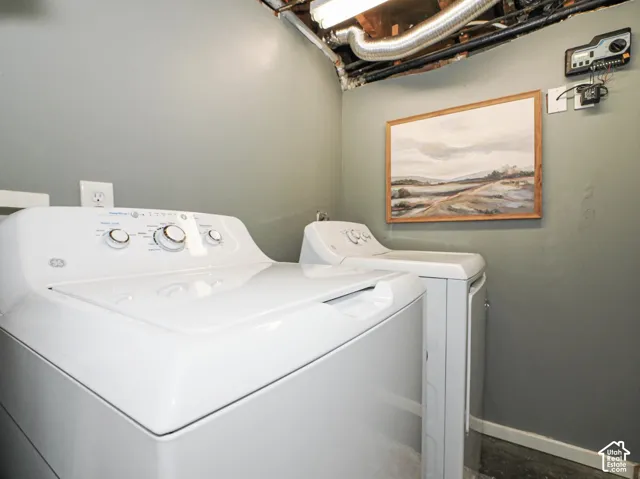 Laundry area with painted walls and exposed utility lines