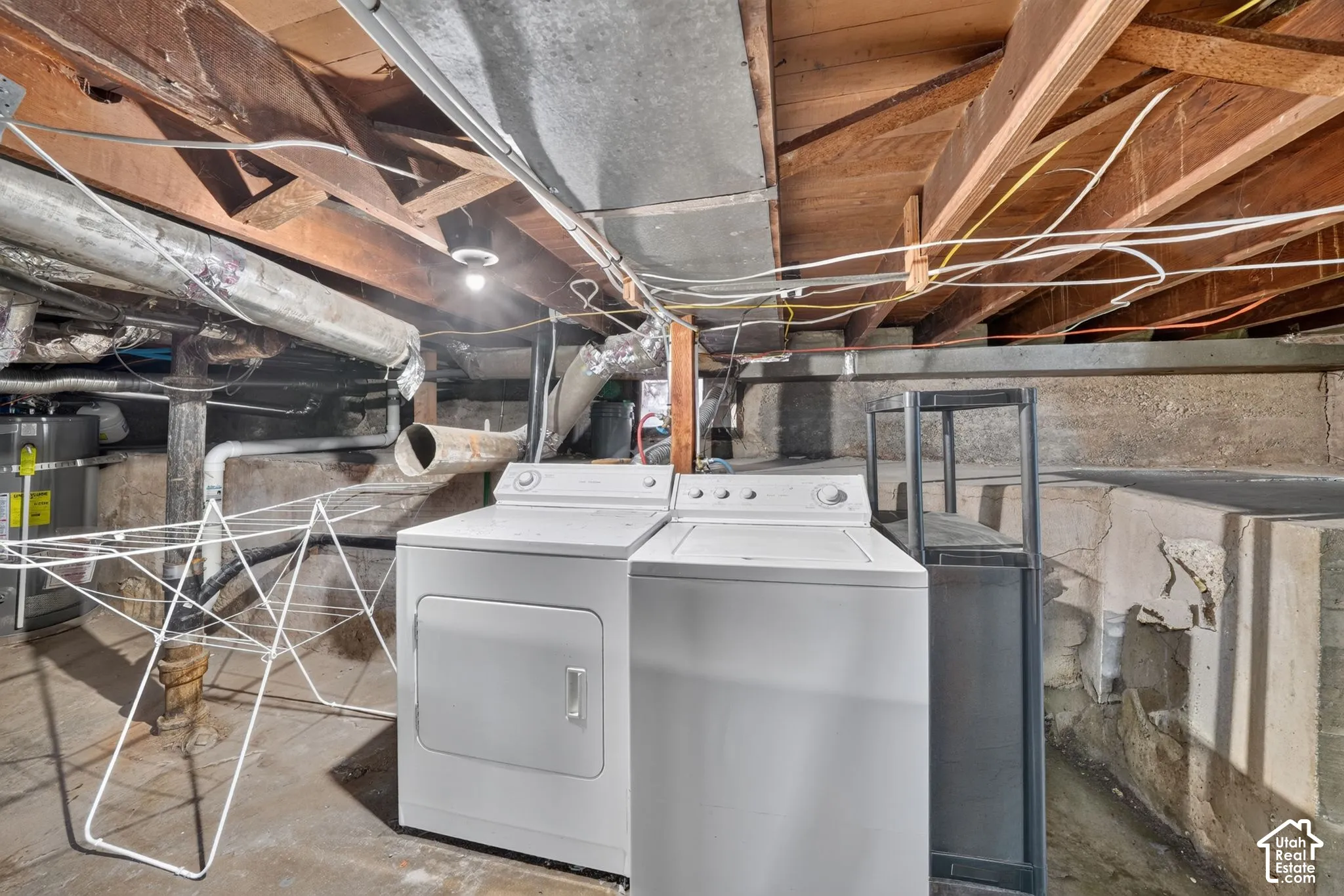 Basement area featuring washer and dryer and storage