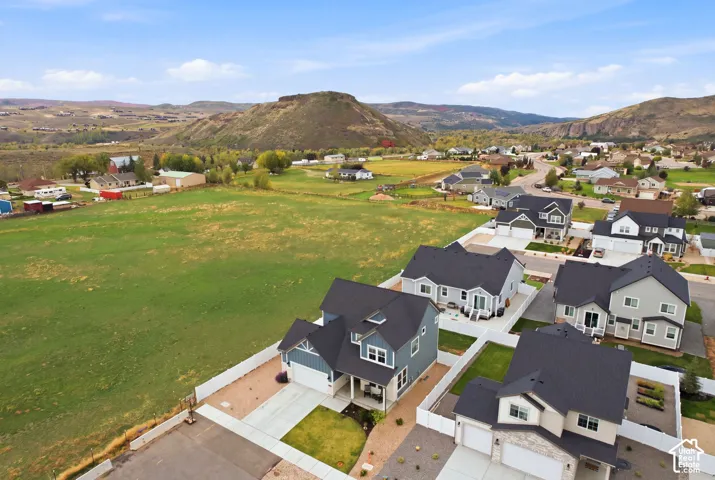 New construction residential development featuring multiple detached homes with two-car garages and fenced yards