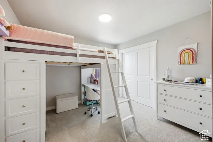 Integrated loft bed with built-in storage, light gray wall paint, white trim, and a flush ceiling light fixture