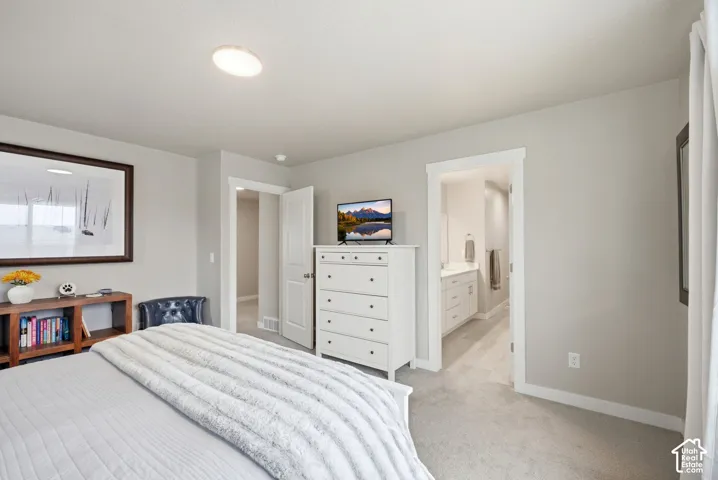 Neutral wall color, recessed ceiling lighting, carpeted flooring, and a white trim doorway leading to an additional space