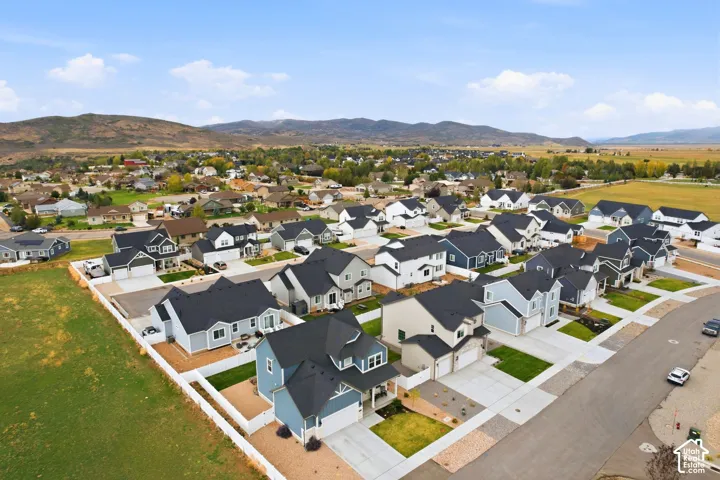 Residential neighborhood featuring a consistent architectural style, paved streets, and adjacent open green spaces