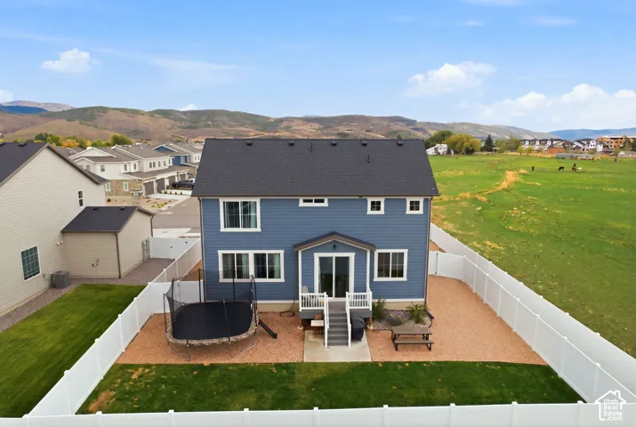 Blue siding exterior with a dark shingle roof