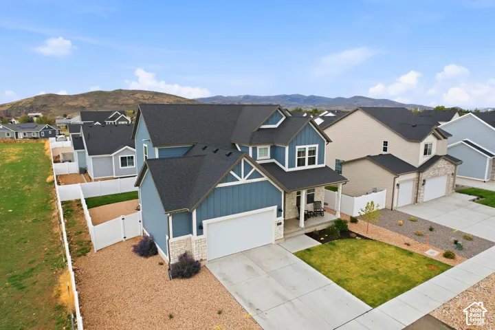 Two-story exterior with blue siding and stone accents