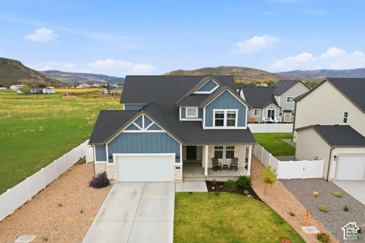 Two-story property with blue siding and stone veneer accents