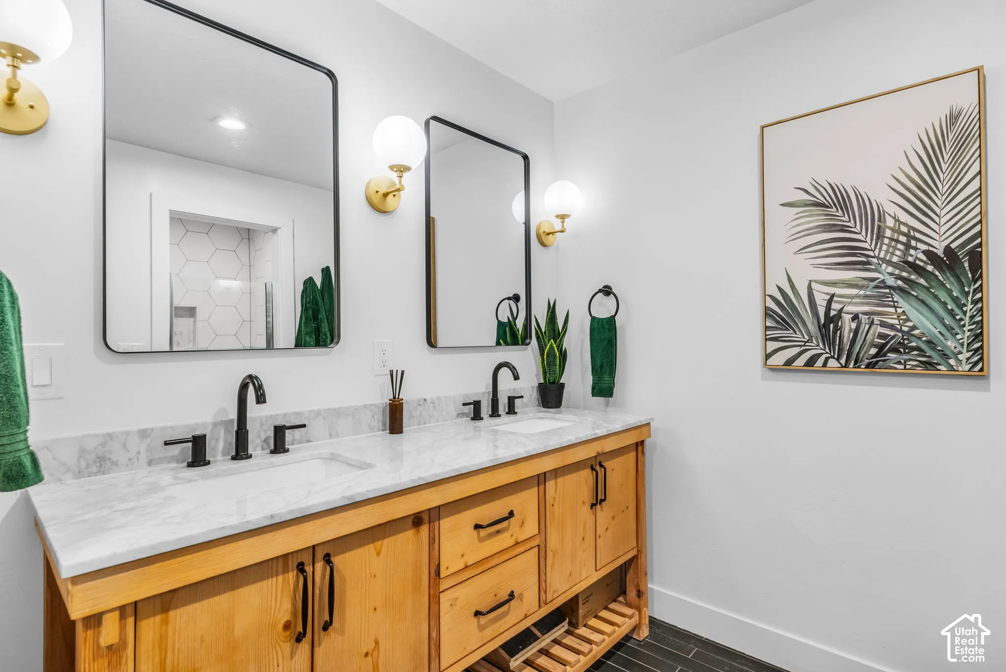 Double vanity with white countertop, dual undermount sinks, and matte black fixtures