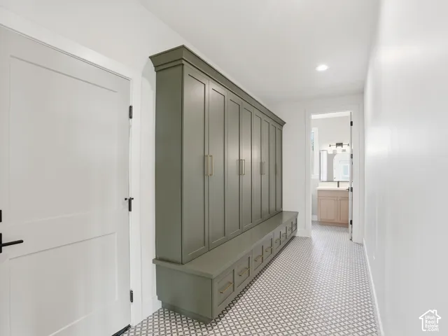 Built-in storage cabinetry with crown molding, integrated bench seating, and drawer storage