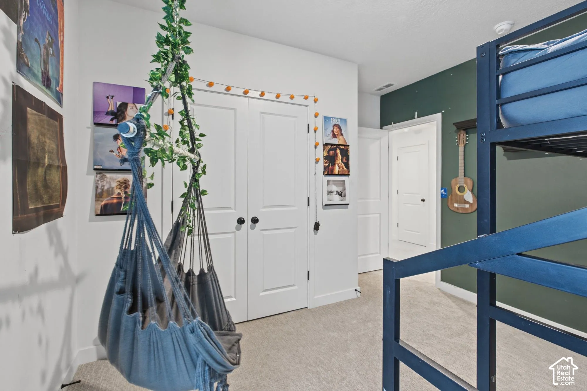 Carpeted flooring, white trim, and a dark green accent wall
