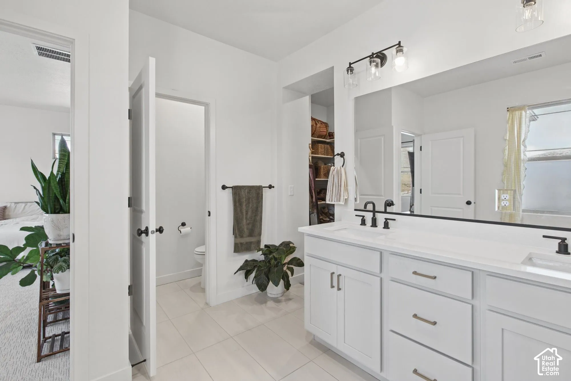 Double vanity with white cabinetry and integrated sinks