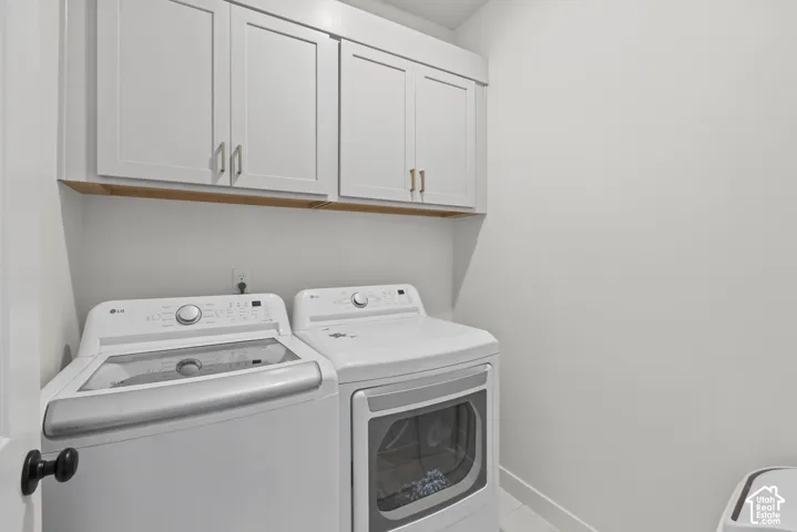 White shaker-style cabinetry with gold-tone hardware