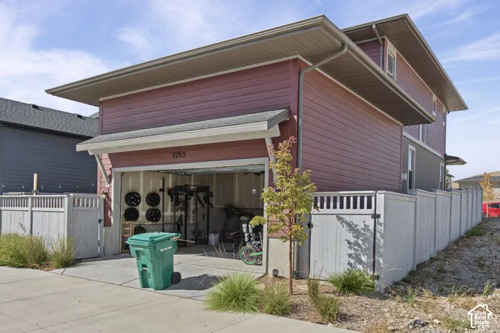 Attached two-car garage with overhead door, and red horizontal siding exterior