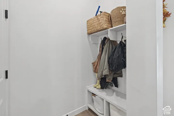 Built-in storage bench with overhead shelving and coat hooks