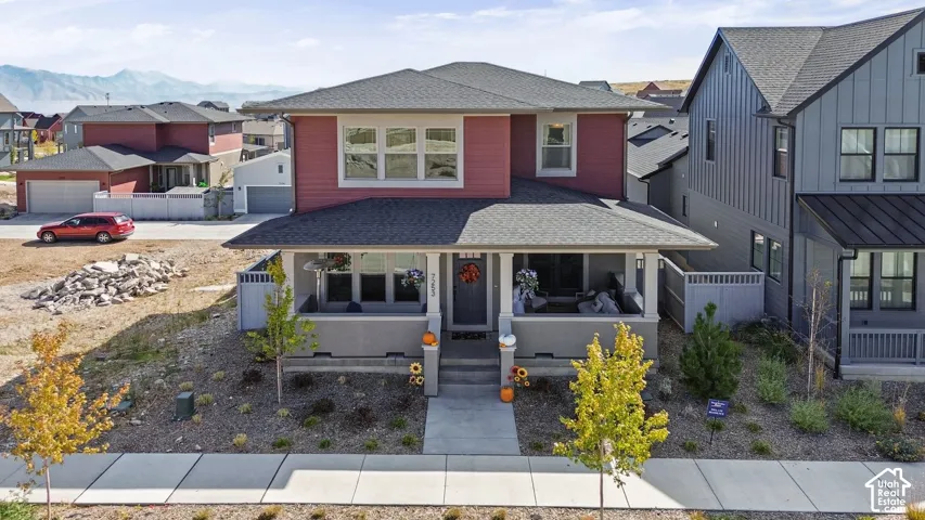 Red siding exterior with a dark roof and white trim