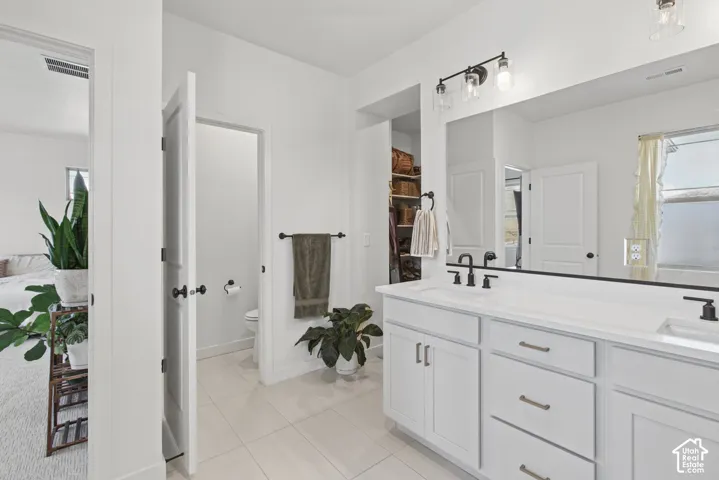 Double vanity with white cabinetry and integrated sinks