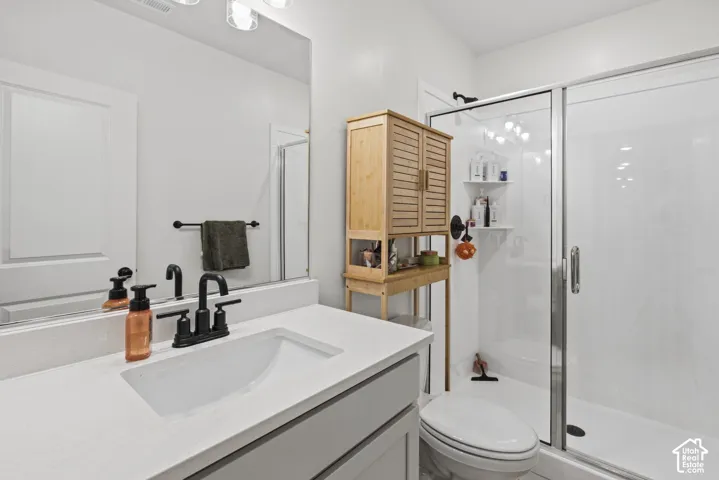 Vanity with integrated sink, black-finish faucet, and full-width mirror
